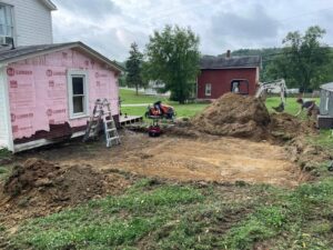 Simplistic Interiors Build Home Additions - Garage with cement driveway